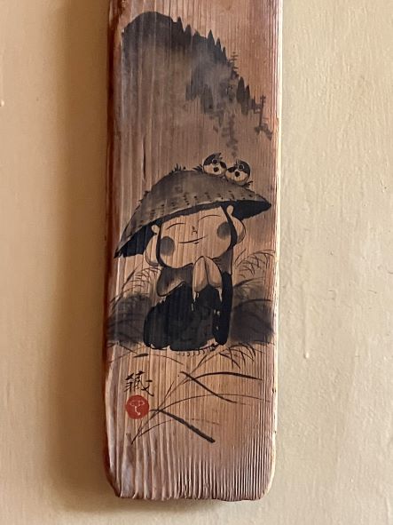 An adorable and highly visible Jizo bodhisattva painted on wood.