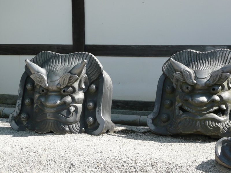 Two kawara tile demon heads at a Kyoto Zen temple.